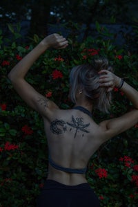 a woman with a dragonfly tattoo on her back