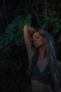 a woman is posing in a forest